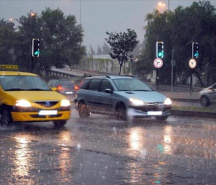 Cars driving along a wet road in the rain